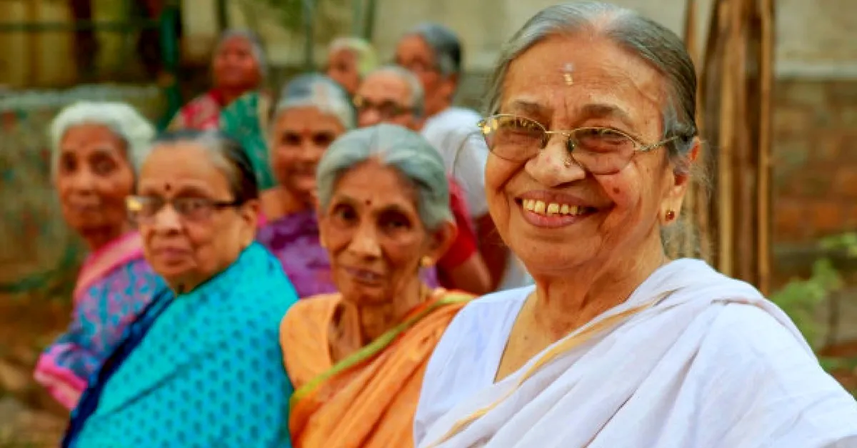 A group of elderly women smiling together outdoors